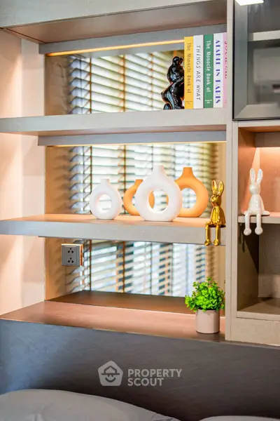 Modern interior shelf with decorative vases and books in stylish living room.