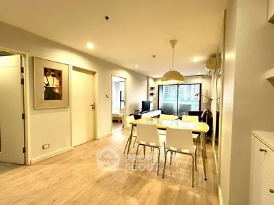 Modern living room with dining area and stylish decor in a cozy apartment.
