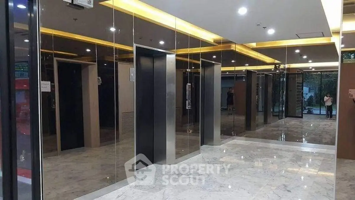 Luxurious modern elevator lobby with marble flooring and mirrored walls