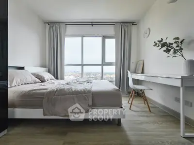 Modern bedroom with large window offering stunning city view and minimalist decor