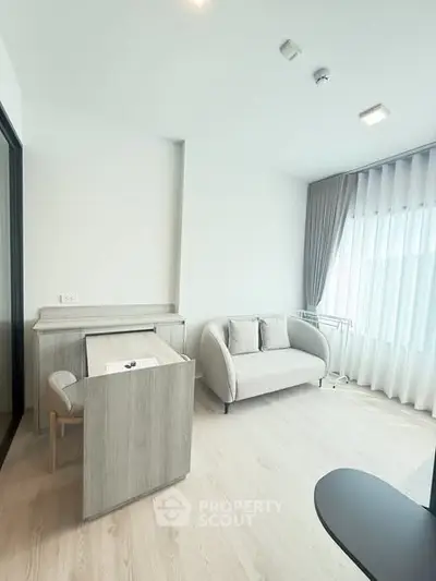 Modern living room with sleek furniture and large window for natural light