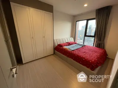 Modern bedroom with city view, featuring a cozy bed and spacious wardrobe.