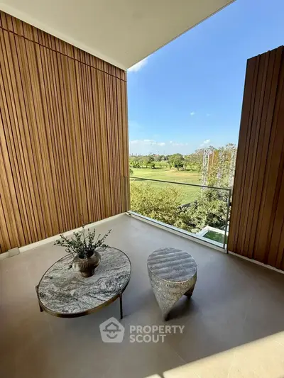 Spacious balcony with stunning view of lush greenery, perfect for relaxation and outdoor enjoyment.