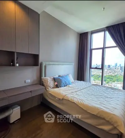 Luxurious bedroom with stunning city view and elegant furnishings in high-rise apartment.
