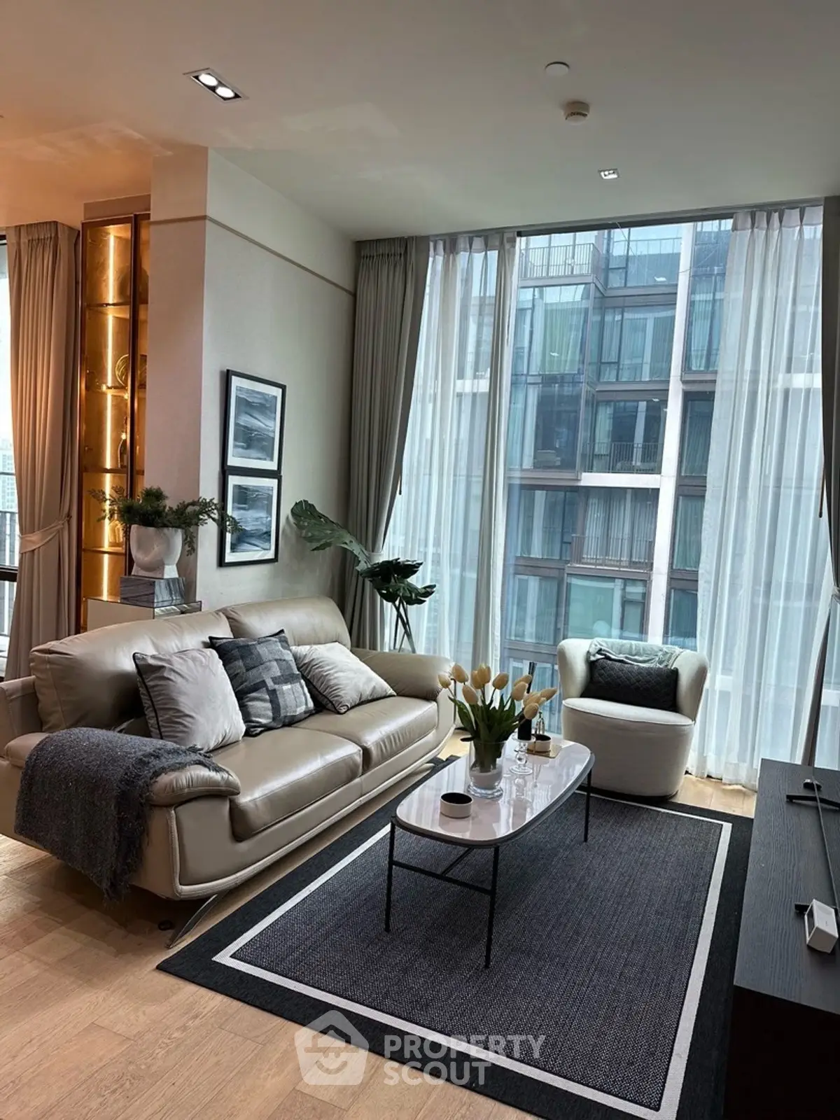 Luxurious modern living room with floor-to-ceiling windows and elegant decor