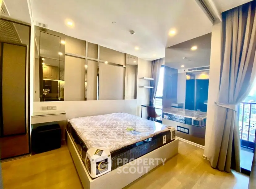 Modern bedroom with large windows and stylish decor in a high-rise apartment.