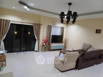 Spacious living room with modern decor and large windows for natural light.