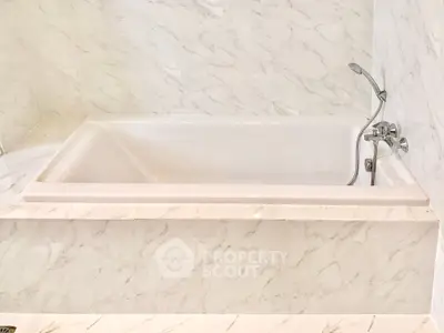 Luxurious marble bathroom with elegant bathtub and modern fixtures