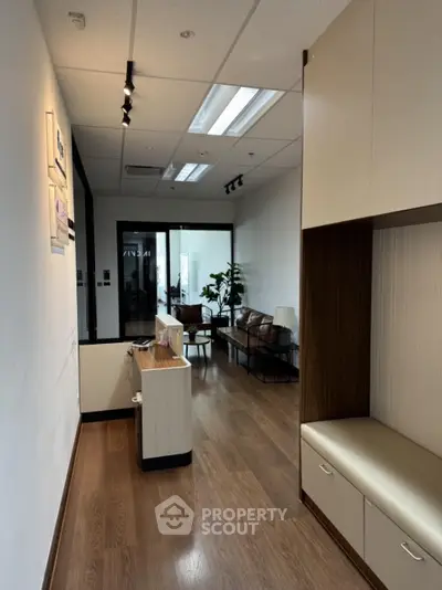Modern office lobby with stylish seating and wooden flooring