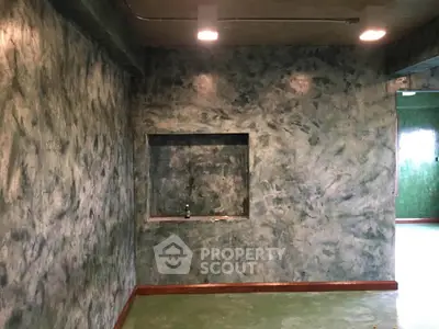 Unique textured wall interior with recessed shelf in modern living space