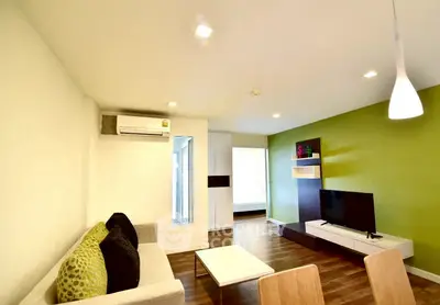 Modern living room with stylish decor and vibrant green accent wall