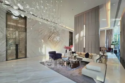 Luxurious modern living room with elegant decor and stunning chandelier in high-end apartment.