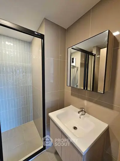 Modern bathroom with sleek sink and glass shower enclosure