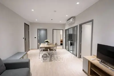 Modern living room with dining area and stylish decor in a contemporary apartment.