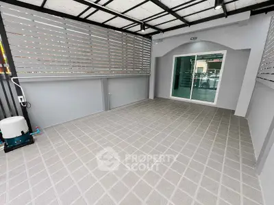Spacious covered patio with modern design and sliding glass doors