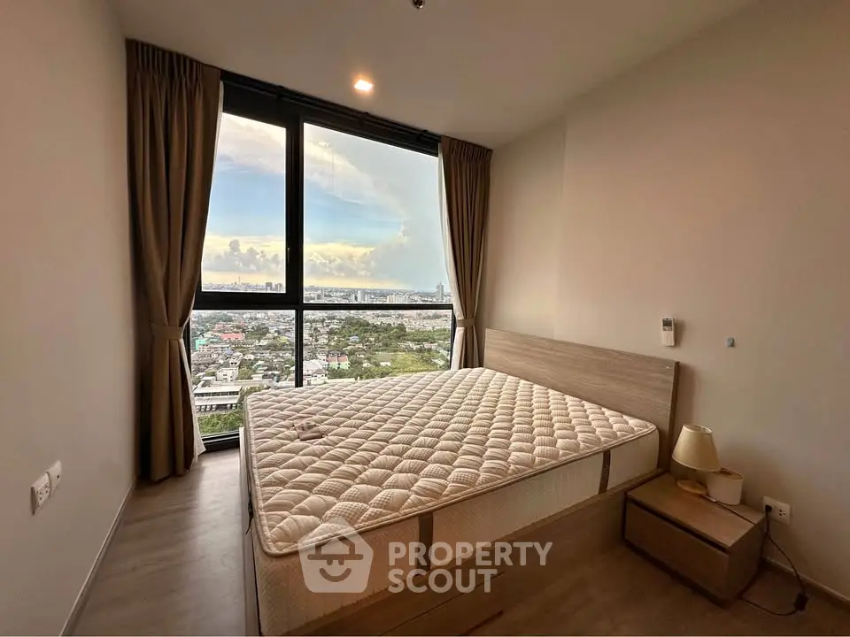 Spacious bedroom with stunning city view and modern furnishings