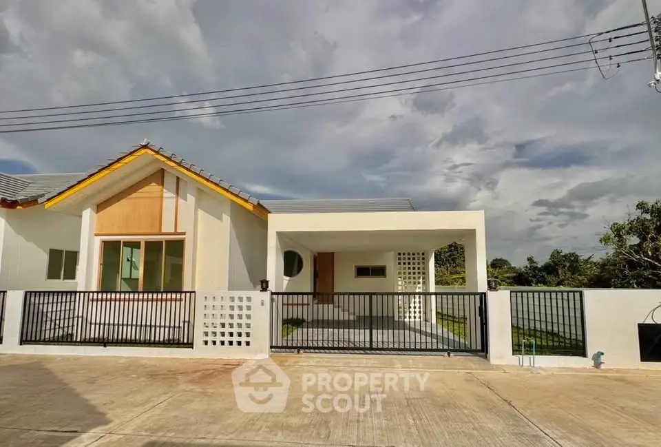 Modern single-story house with a spacious driveway and contemporary design.