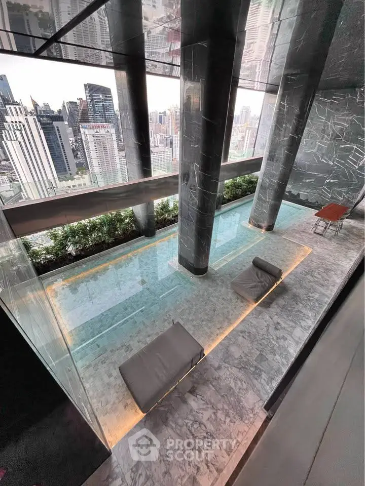 Luxurious high-rise building with stunning city view and elegant pool area.