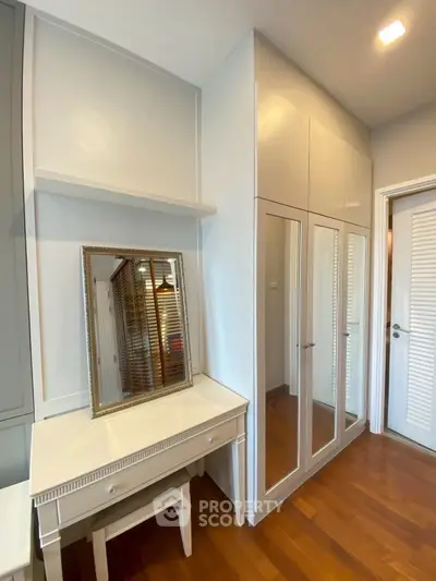 Elegant bedroom with mirrored wardrobe and stylish vanity table
