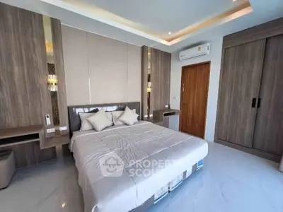 Modern bedroom with sleek design, featuring a comfortable bed, built-in wardrobe, and air conditioning.