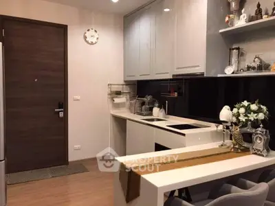 Modern kitchen with sleek design and open layout, featuring stylish decor and efficient use of space.