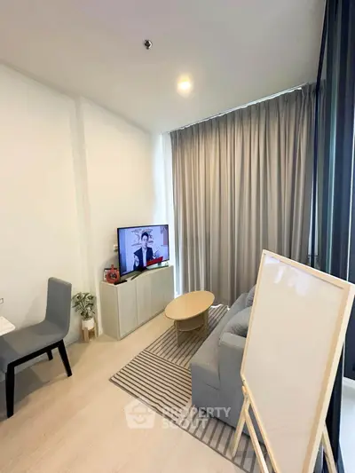 Modern living room with sleek furniture and large window, perfect for urban living.