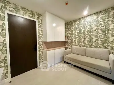 Stylish living room with modern sofa and tropical wallpaper, perfect for relaxation.