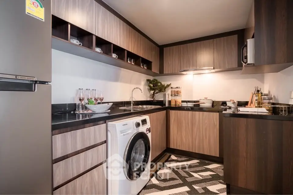 Modern kitchen with sleek wooden cabinets and built-in washing machine