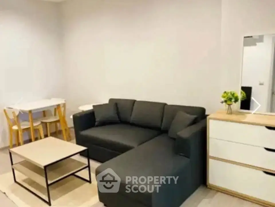 Modern living room with sleek black sofa and minimalist decor