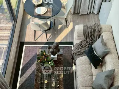 Modern living room with stylish decor and large windows offering city views.
