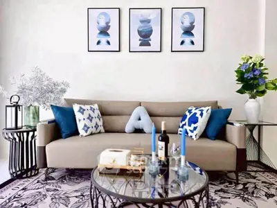 Stylish living room with modern decor, elegant sofa, and artistic wall art.