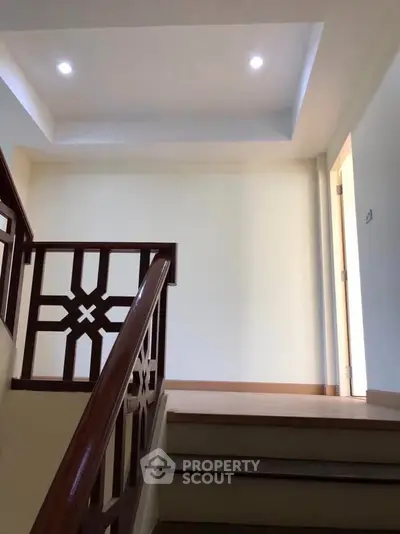 Elegant staircase with wooden railing in a modern home interior