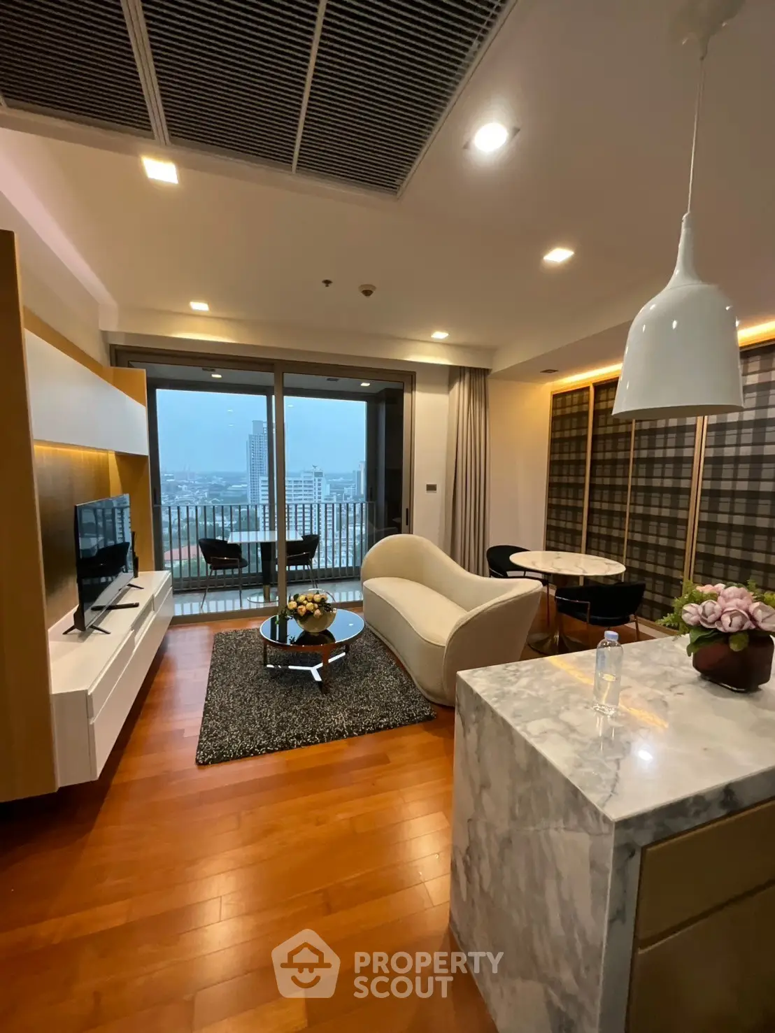 Modern living room with city view, stylish furniture, and open layout in luxury apartment.