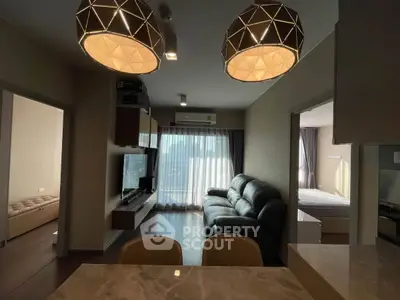 Modern living room with stylish lighting and cozy seating area in a contemporary apartment.