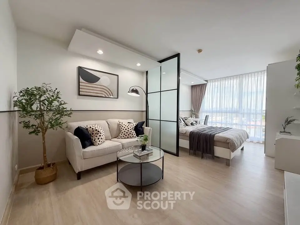 Modern open-plan living room with stylish decor and natural light