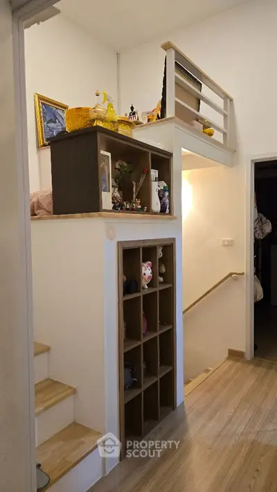 Charming loft-style interior with wooden stairs and decorative shelving