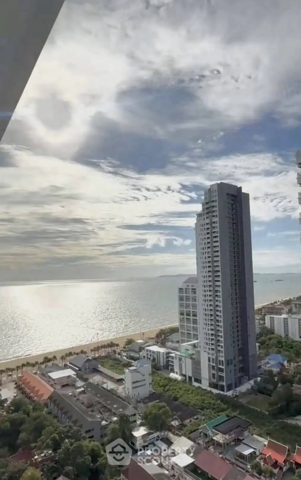 Stunning ocean view from high-rise building overlooking the beach and cityscape.