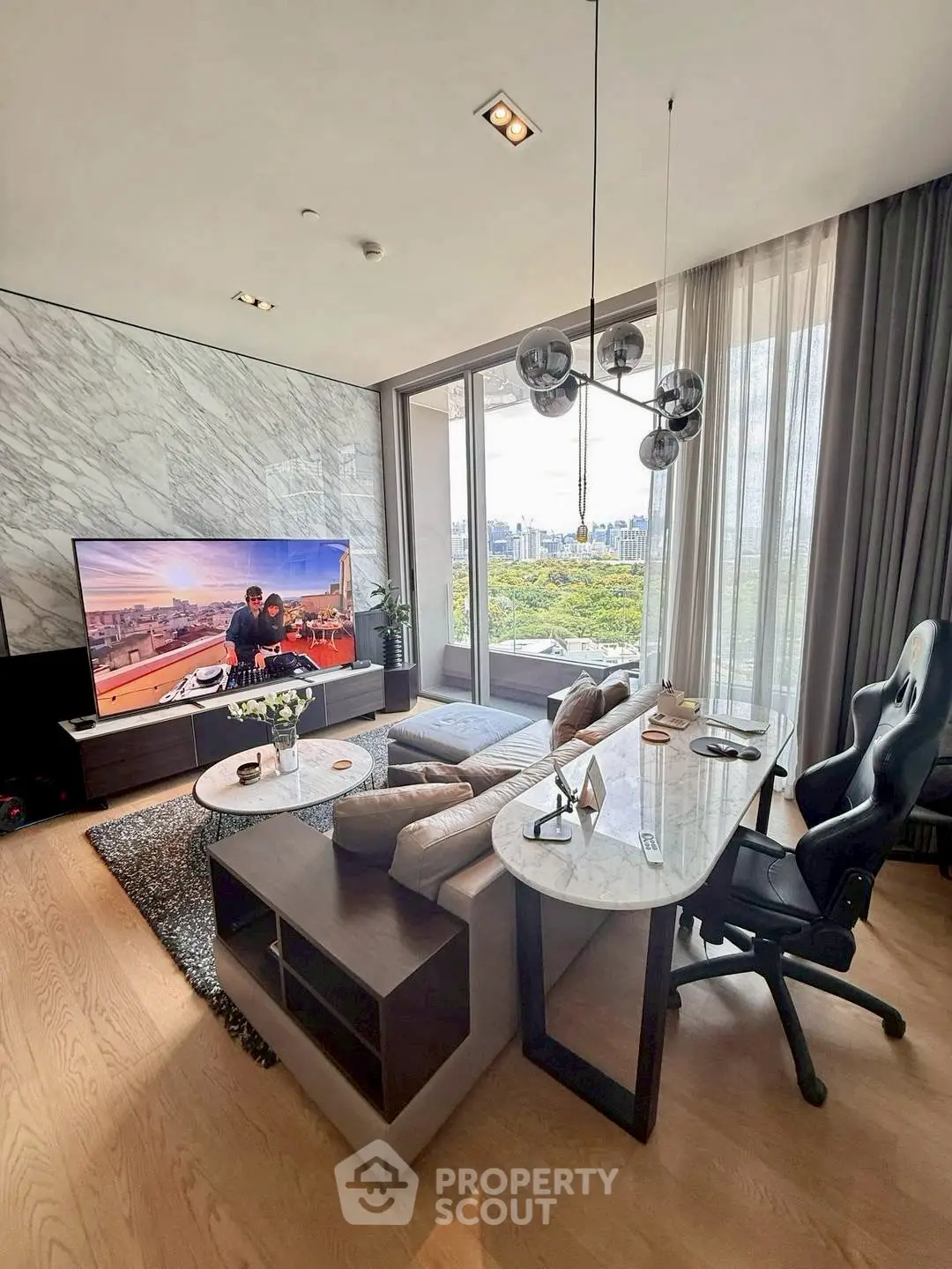 Luxurious living room with modern decor and stunning city view through large windows.