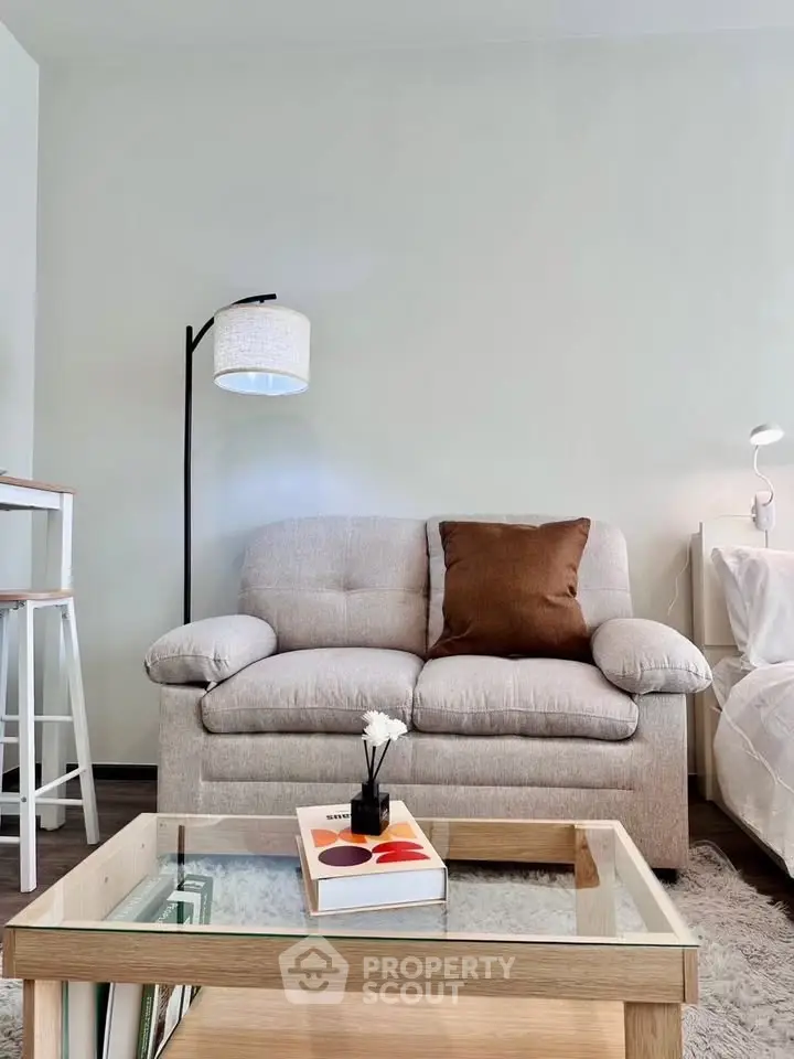 Cozy living room with plush sofa and modern decor, perfect for relaxation.