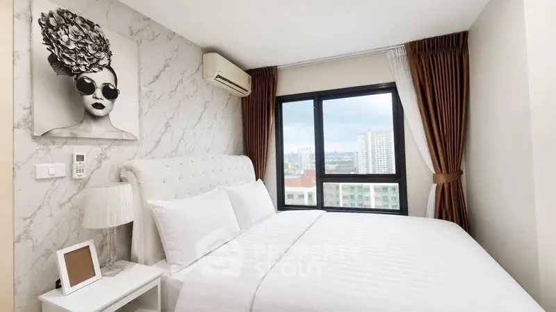 Modern bedroom with stylish decor and city view, featuring a comfortable bed and elegant furnishings.
