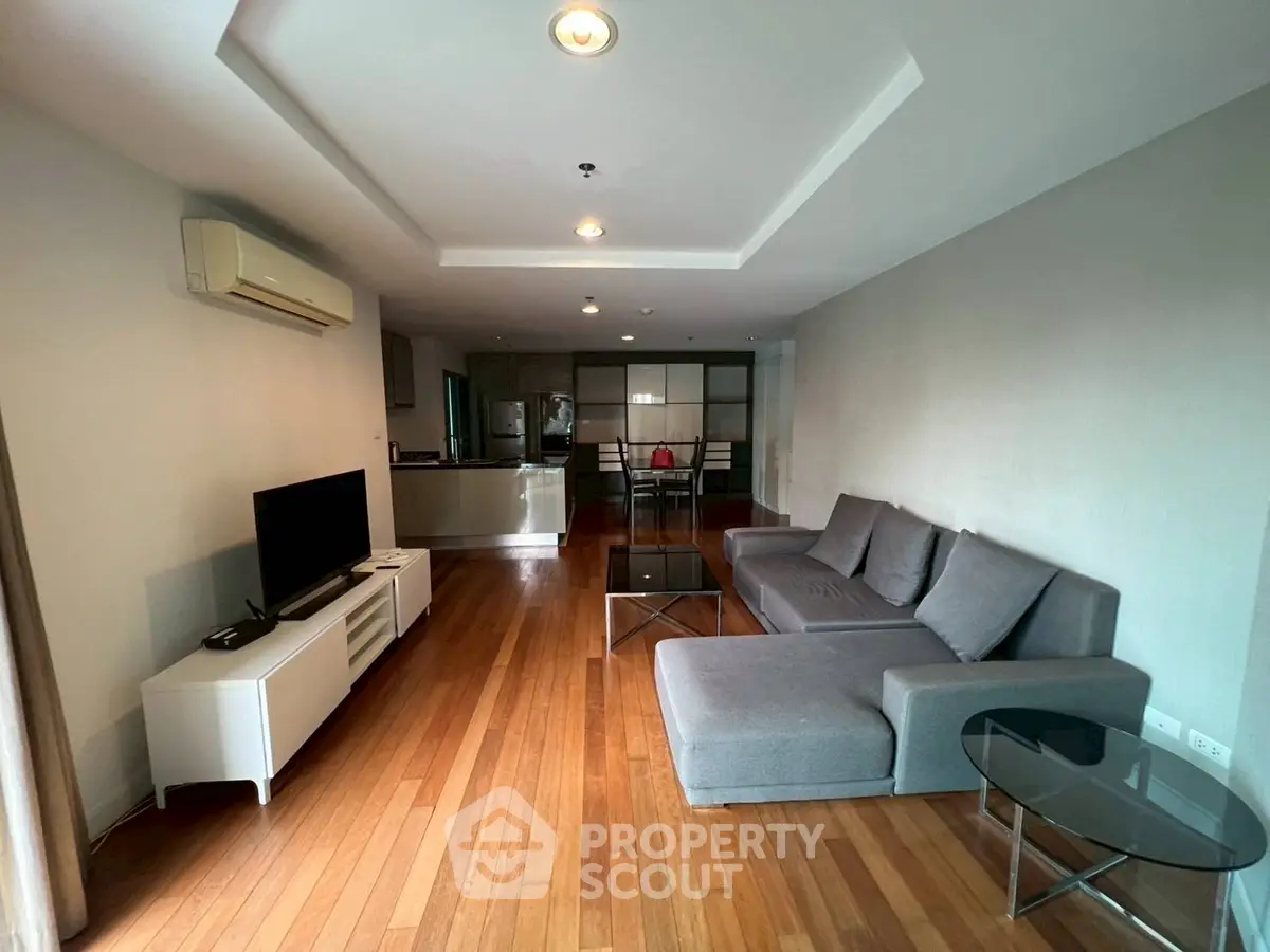 Spacious modern living room with sleek furniture and wooden flooring