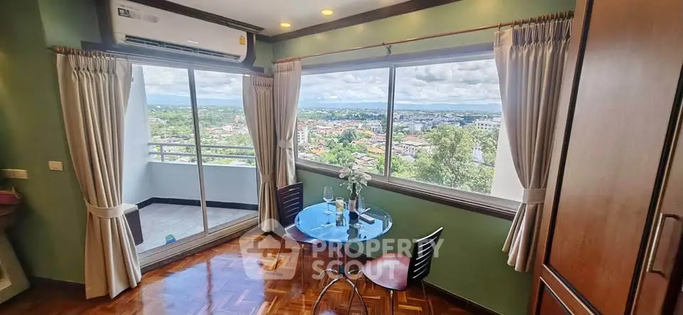 Charming living room with stunning city view and cozy balcony access