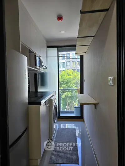 Modern kitchen with sleek appliances and large window view