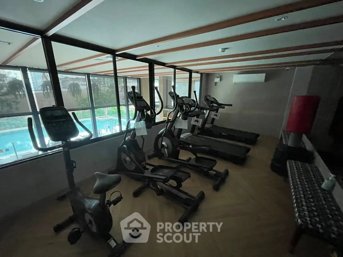 Modern gym with exercise bikes and treadmills in a well-lit space.