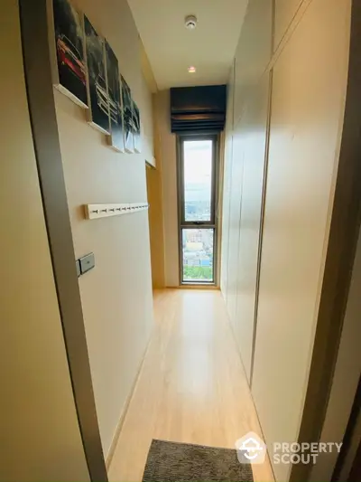 Stylish narrow hallway with modern decor and city view window