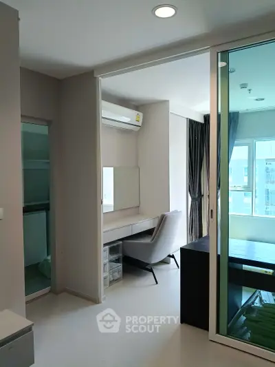 Modern study area with glass partition and natural light in a stylish apartment.