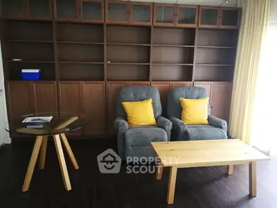 Cozy living room with recliner chairs and wooden furniture, perfect for relaxation.