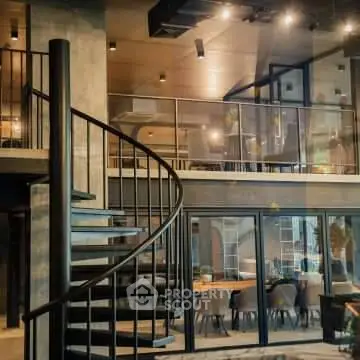 Luxurious modern loft with spiral staircase and open dining area, perfect for urban living.