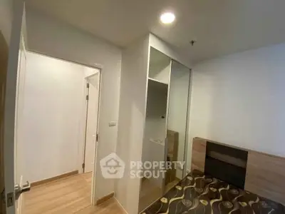 Modern bedroom with sleek design and built-in wardrobe in a stylish apartment.