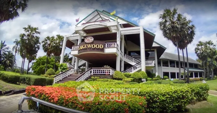 Stunning exterior view of a luxurious building surrounded by lush greenery and palm trees.